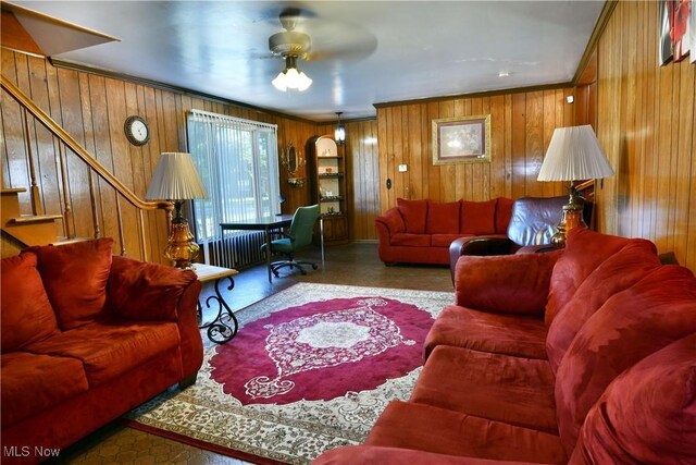 2816 E Market St, Warren, OH 44483 - living room with wooden walls, a ceiling fan, stairs, and crown molding