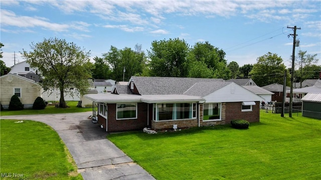 3205 State Rd, Ashtabula, OH 44004 - view of front facade featuring a front yard, brick siding, and asphalt driveway