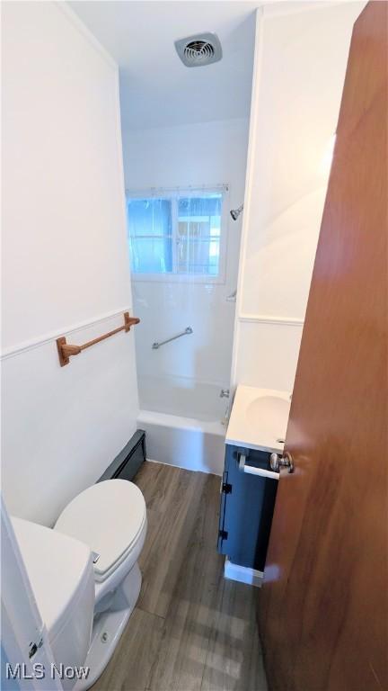 3205 State Rd, Ashtabula, OH 44004 - bathroom featuring toilet, wood finished floors, vanity, and shower / tub combination