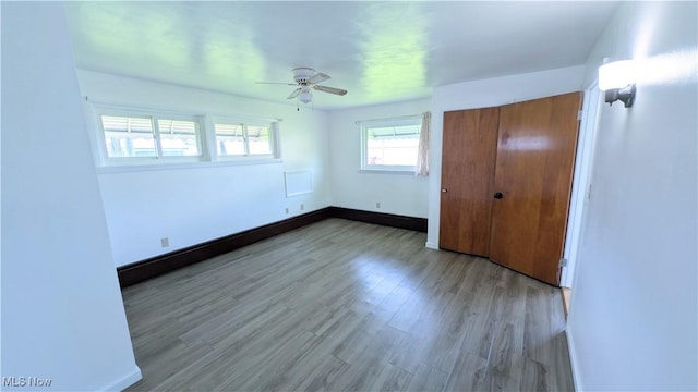 3205 State Rd, Ashtabula, OH 44004 - unfurnished bedroom featuring wood finished floors, baseboards, and a ceiling fan