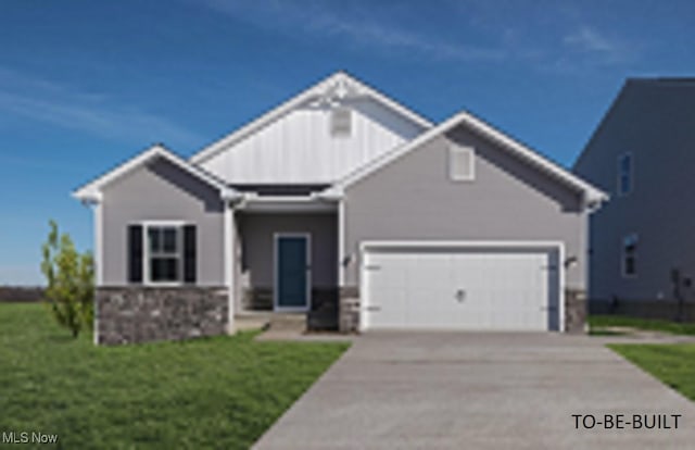 4367 Main St, Perry, OH 44081 - view of front of property with an attached garage, stone siding, driveway, and a front lawn