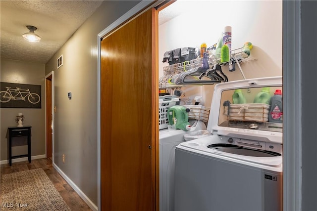 2993 Harris Hwy, Washington, WV 26181 - laundry area with a textured ceiling, wood finished floors, and baseboards