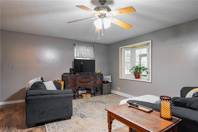 2993 Harris Hwy, Washington, WV 26181 - living room featuring baseboards, ceiling fan, and a textured ceiling