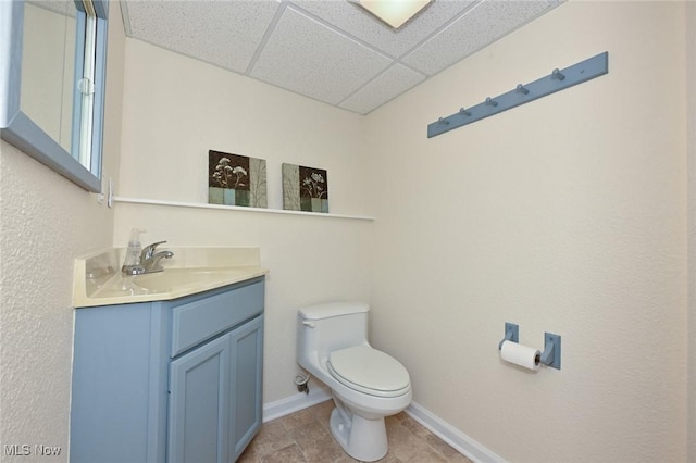 947 Trimble Pl, Sagamore Hills, OH 44067 - half bathroom with a paneled ceiling, toilet, vanity, and baseboards