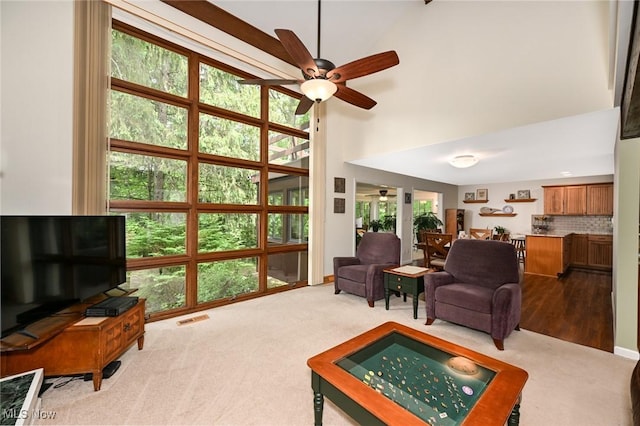 947 Trimble Pl, Sagamore Hills, OH 44067 - living area with a ceiling fan, a towering ceiling, and carpet flooring