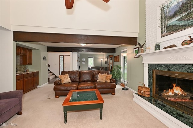 947 Trimble Pl, Sagamore Hills, OH 44067 - living area with light carpet, a ceiling fan, a fireplace, and baseboards