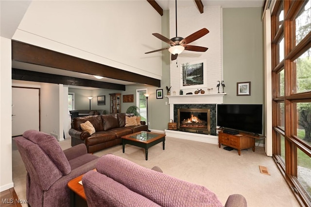 947 Trimble Pl, Sagamore Hills, OH 44067 - living area with carpet flooring, high vaulted ceiling, a fireplace, beam ceiling, and a ceiling fan