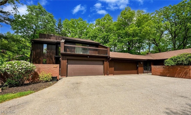 947 Trimble Pl, Sagamore Hills, OH 44067 - view of front of house with driveway, a balcony, and an attached garage