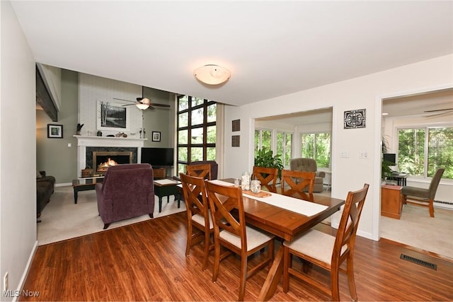 947 Trimble Pl, Sagamore Hills, OH 44067 - dining room featuring a ceiling fan, a high end fireplace, and dark wood-type flooring