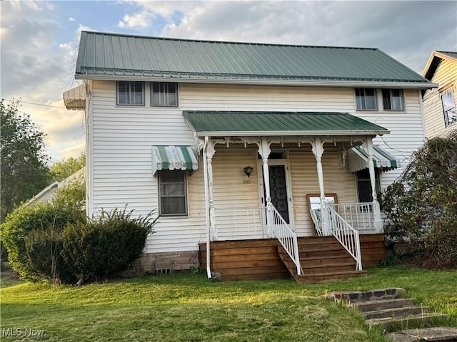 202 E Spring St, Bethesda, OH 43719 - view of front facade with a front yard, metal roof, and a porch