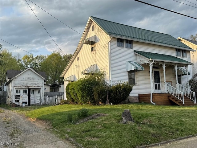 202 E Spring St, Bethesda, OH 43719 - view of front of house featuring a front lawn, metal roof, and an outdoor structure