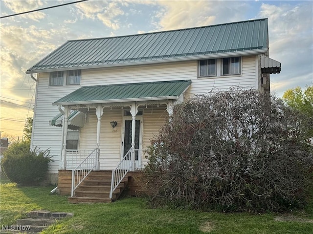 202 E Spring St, Bethesda, OH 43719 - view of front of property with metal roof, a porch, and a front lawn