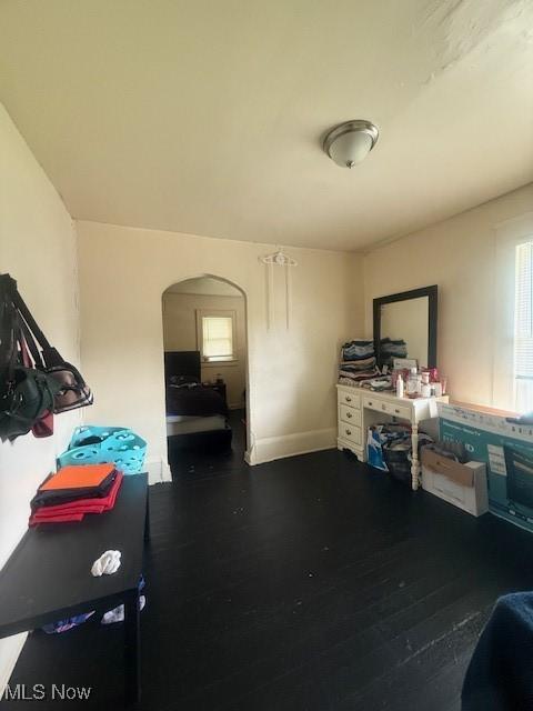 639 Bellevue Ave, Akron, OH 44307 - misc room with arched walkways, wood finished floors, healthy amount of natural light, and baseboards