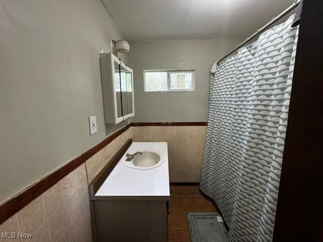 14014 Sylvia Ave, Cleveland, OH 44110 - full bath with tile walls, vanity, a wainscoted wall, and a shower with curtain