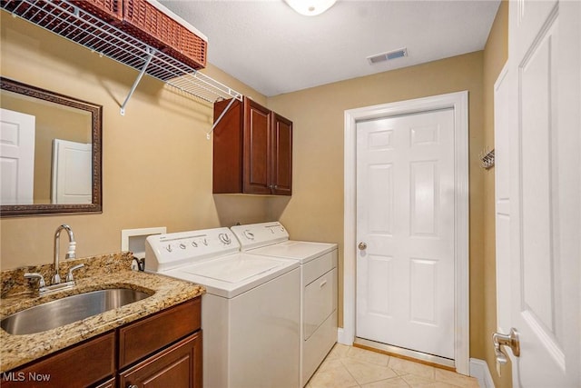29 Amber Way, Norwalk, OH 44857 - washroom featuring washing machine and clothes dryer, cabinet space, light tile patterned floors, and baseboards