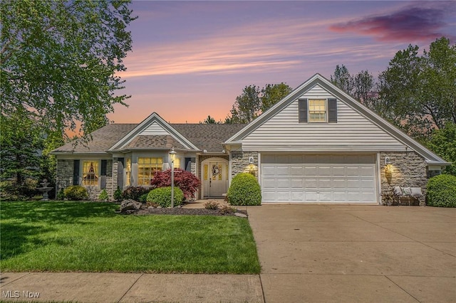 29 Amber Way, Norwalk, OH 44857 - view of front of house featuring stone siding, driveway, a yard, and a garage