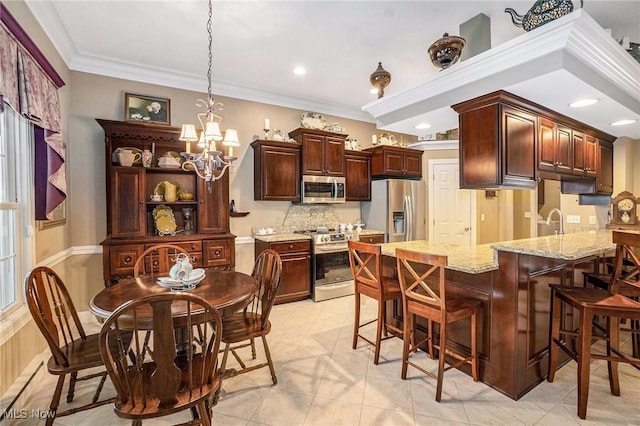 29 Amber Way, Norwalk, OH 44857 - kitchen with stainless steel appliances, a peninsula, a chandelier, decorative backsplash, and ornamental molding
