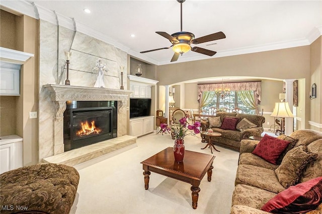 29 Amber Way, Norwalk, OH 44857 - living area featuring a fireplace, a ceiling fan, ornamental molding, carpet flooring, and arched walkways