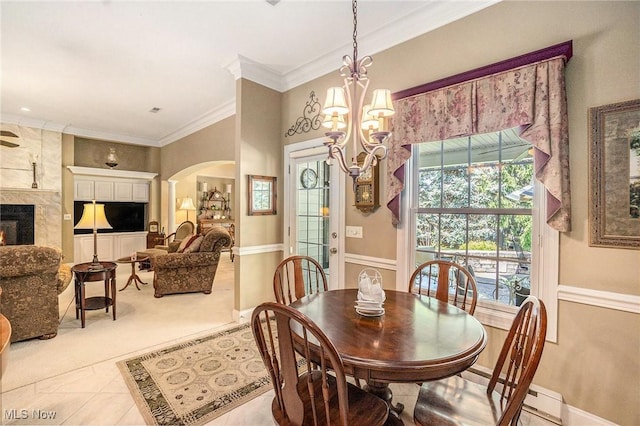 29 Amber Way, Norwalk, OH 44857 - dining area featuring arched walkways, a chandelier, crown molding, a premium fireplace, and baseboards