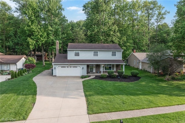 27539 Linwood Cir, North Olmsted, OH 44070 - traditional-style house with covered porch, driveway, a front lawn, and an attached garage