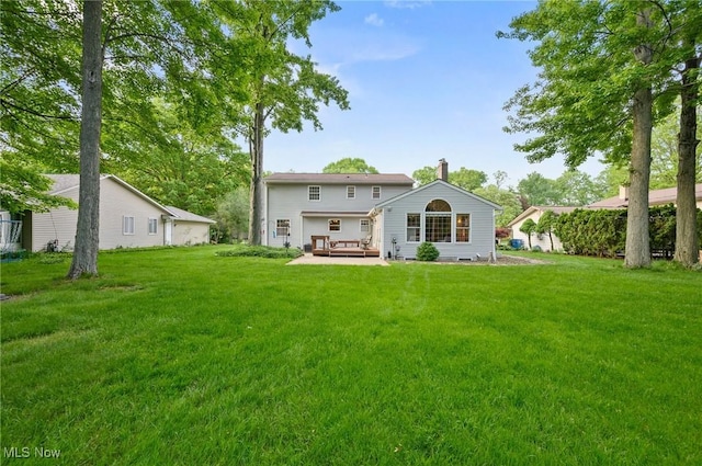 27539 Linwood Cir, North Olmsted, OH 44070 - back of house with a deck, a lawn, and a chimney