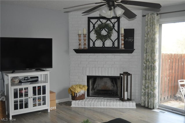 1883 Ridge Meadow Ct, Twinsburg, OH 44087 - living room with a ceiling fan, wood finished floors, and a fireplace