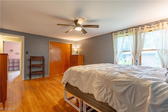 3796 Sweitzer St NW, Uniontown, OH 44685 - bedroom featuring light wood finished floors, a closet, and ceiling fan