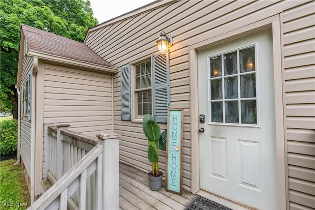 3796 Sweitzer St NW, Uniontown, OH 44685 - view of exterior entry featuring a wooden deck and a shingled roof