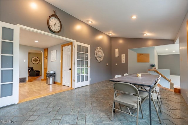 3796 Sweitzer St NW, Uniontown, OH 44685 - dining space featuring stone tile floors, lofted ceiling, arched walkways, recessed lighting, and baseboards