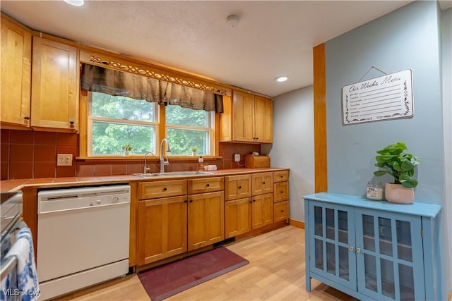3796 Sweitzer St NW, Uniontown, OH 44685 - kitchen with dishwasher, a sink, light wood-style flooring, backsplash, and recessed lighting
