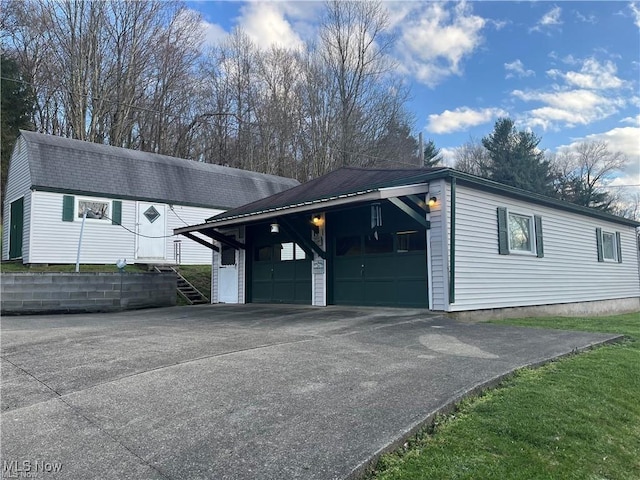 20022 County Road 6, Coshocton, OH 43812 - view of side of property featuring a garage, driveway, and an outbuilding