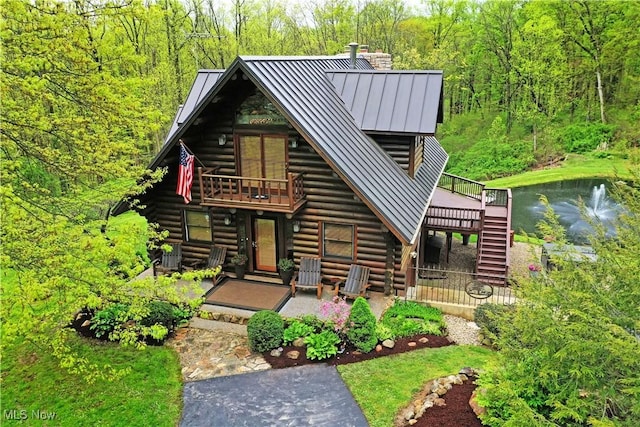 18102 Owen Rd, Middlefield, OH 44062 - log home featuring a standing seam roof, log siding, stairway, metal roof, and a chimney