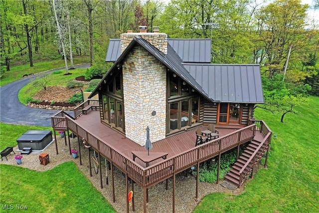 18102 Owen Rd, Middlefield, OH 44062 - rear view of property with a standing seam roof, a chimney, log exterior, and a wooden deck