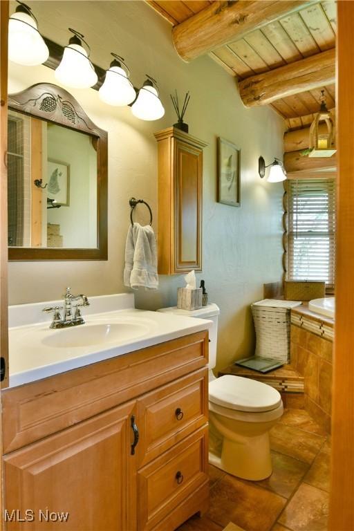 18102 Owen Rd, Middlefield, OH 44062 - bathroom with wood ceiling with exposed beams, toilet, and vanity
