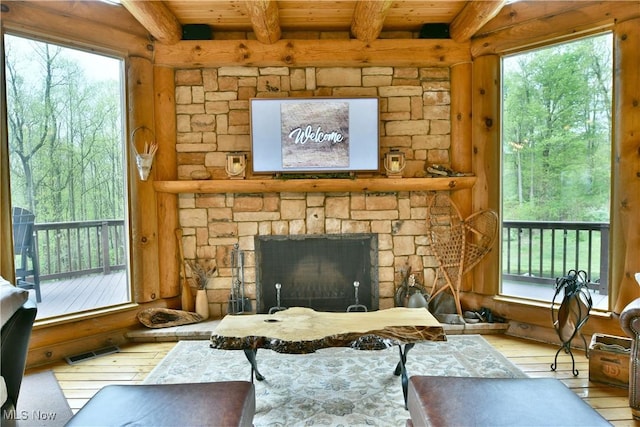 18102 Owen Rd, Middlefield, OH 44062 - living room with hardwood / wood-style flooring, wooden ceiling with exposed beams, and a stone fireplace