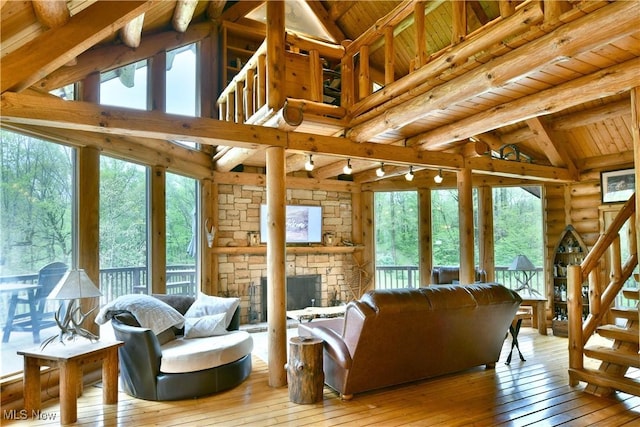 18102 Owen Rd, Middlefield, OH 44062 - living room with wood ceiling, light wood-type flooring, stairway, and healthy amount of natural light