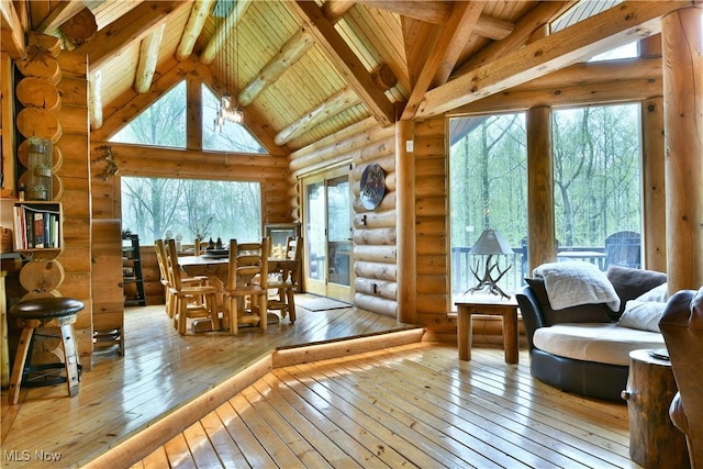 18102 Owen Rd, Middlefield, OH 44062 - dining room featuring log walls, hardwood / wood-style flooring, wood ceiling with exposed beams, and high vaulted ceiling