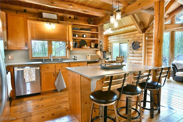 18102 Owen Rd, Middlefield, OH 44062 - kitchen with stainless steel dishwasher, wooden ceiling with exposed beams, log walls, light wood-style flooring, and a center island