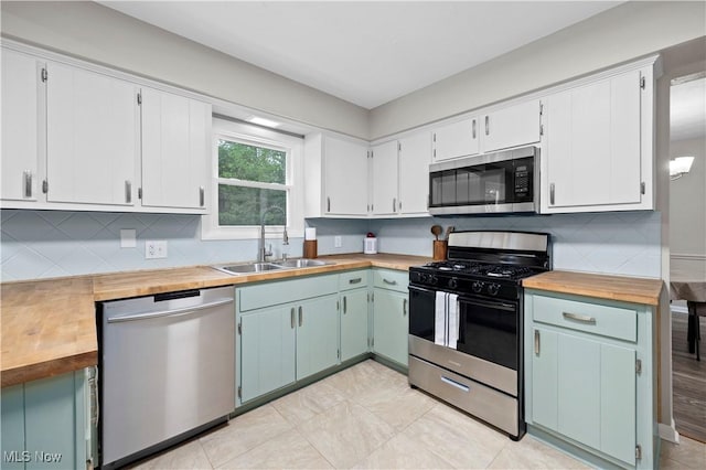 1704 Emerald Dr, Lorain, OH 44053 - kitchen featuring stainless steel appliances, butcher block countertops, a sink, and backsplash