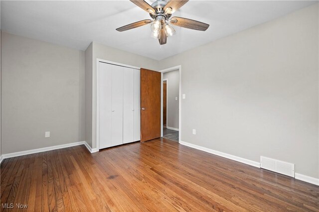 1704 Emerald Dr, Lorain, OH 44053 - unfurnished bedroom with baseboards, a closet, wood finished floors, and ceiling fan