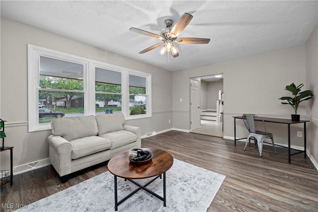 1704 Emerald Dr, Lorain, OH 44053 - living area featuring plenty of natural light, a ceiling fan, baseboards, wood finished floors, and a textured ceiling