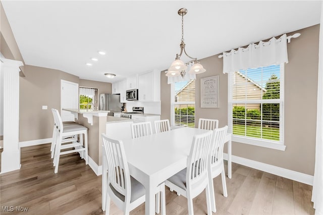 1487 Barrymore Ln, Wadsworth, OH 44281 - dining room with baseboards, decorative columns, light wood-style flooring, and recessed lighting