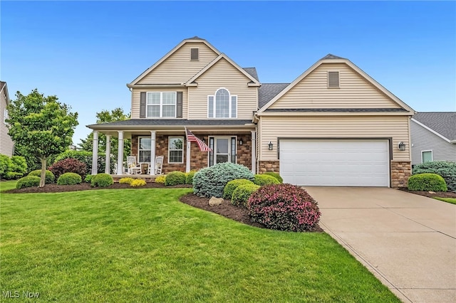1487 Barrymore Ln, Wadsworth, OH 44281 - view of front of house featuring driveway, an attached garage, covered porch, a front yard, and stone siding