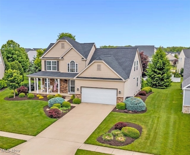 1487 Barrymore Ln, Wadsworth, OH 44281 - view of front of property with a porch, stone siding, driveway, an attached garage, and a front yard