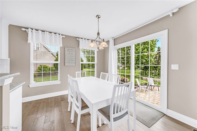 1487 Barrymore Ln, Wadsworth, OH 44281 - dining space featuring a chandelier, baseboards, healthy amount of natural light, and light wood finished floors