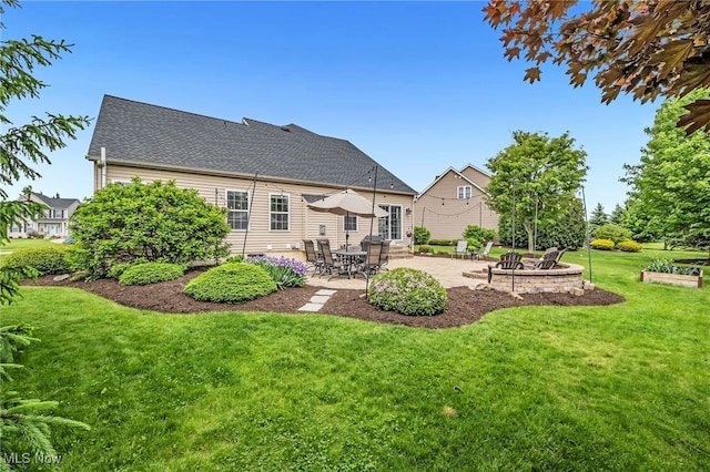 1487 Barrymore Ln, Wadsworth, OH 44281 - rear view of property featuring a patio, a yard, and a fire pit