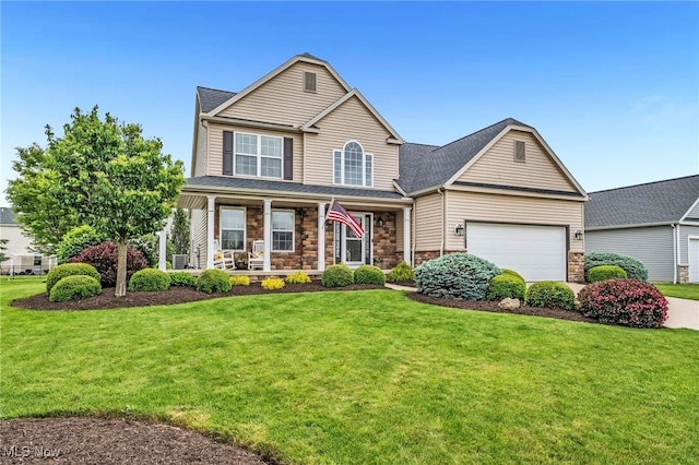 1487 Barrymore Ln, Wadsworth, OH 44281 - traditional-style home featuring covered porch, a front lawn, and stone siding