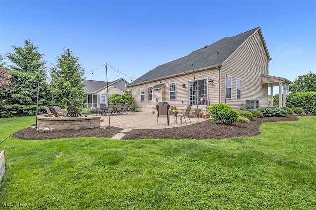 1487 Barrymore Ln, Wadsworth, OH 44281 - back of house featuring a patio area, a lawn, central air condition unit, and a shingled roof