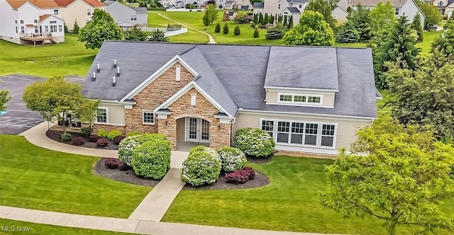 1487 Barrymore Ln, Wadsworth, OH 44281 - view of front facade with stone siding, a residential view, and a front yard