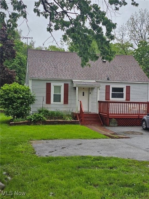 5076 State Route 43, Kent, OH 44240 - cape cod-style house featuring a front lawn, a shingled roof, and a wooden deck